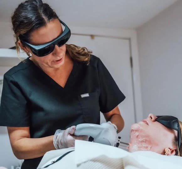 Liz giving a laser treatment